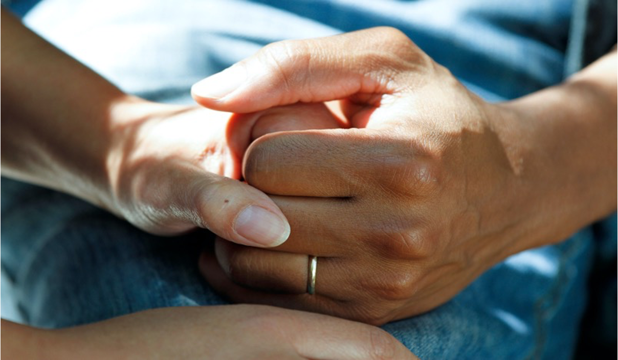 Two women holding hands